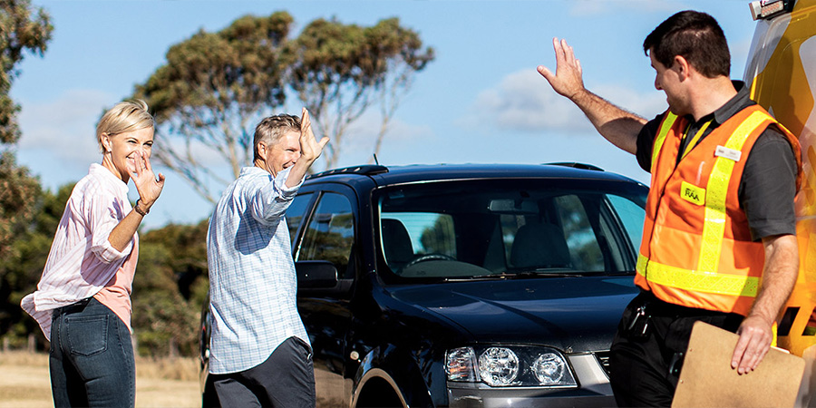 RAA patrol waving goodbye to a couple at the roadside